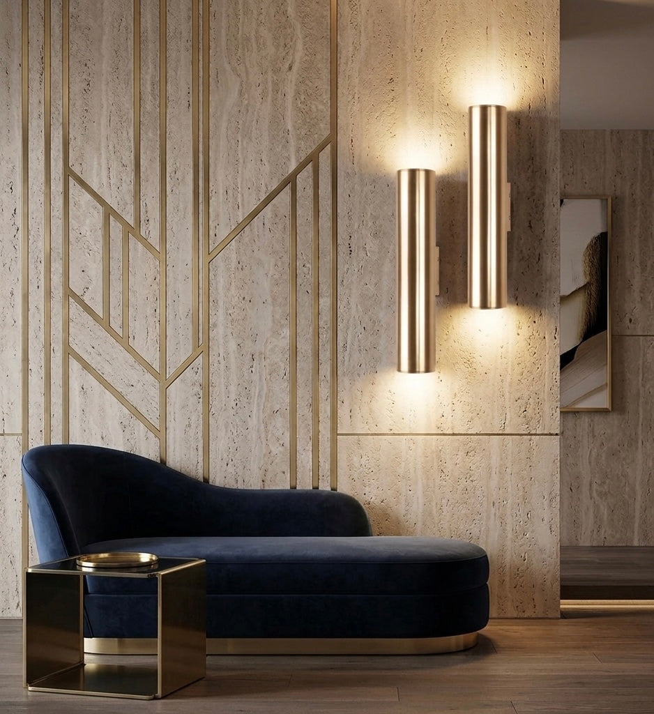 Modern interior with a blue velvet sofa and gold accent table against a textured wall.