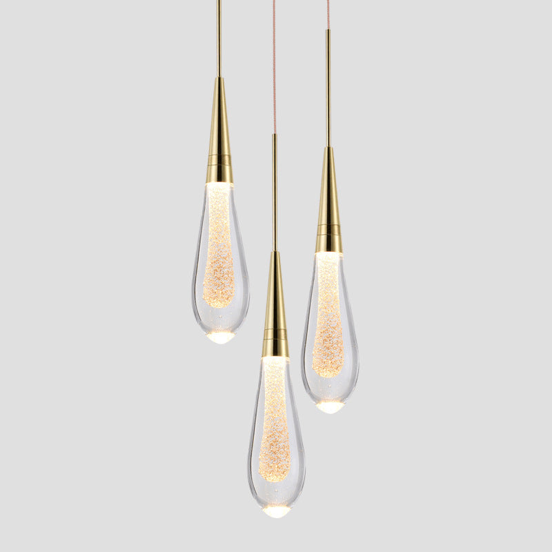 Three modern pendant lights with gold accents on a gray background