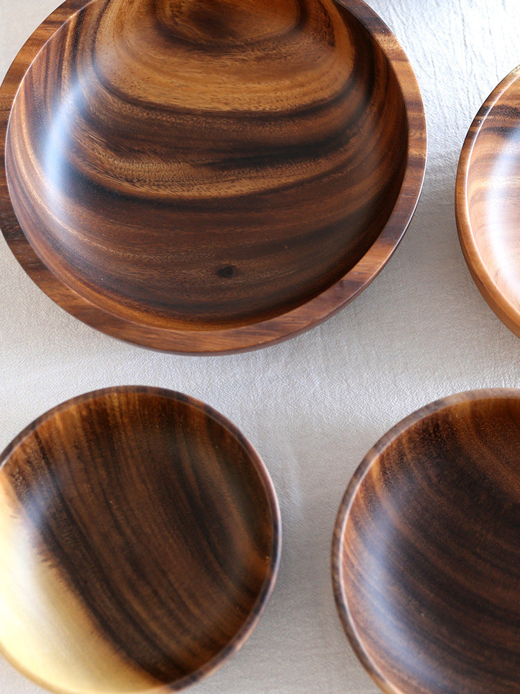 Set of wooden bowls with a natural finish on a light background