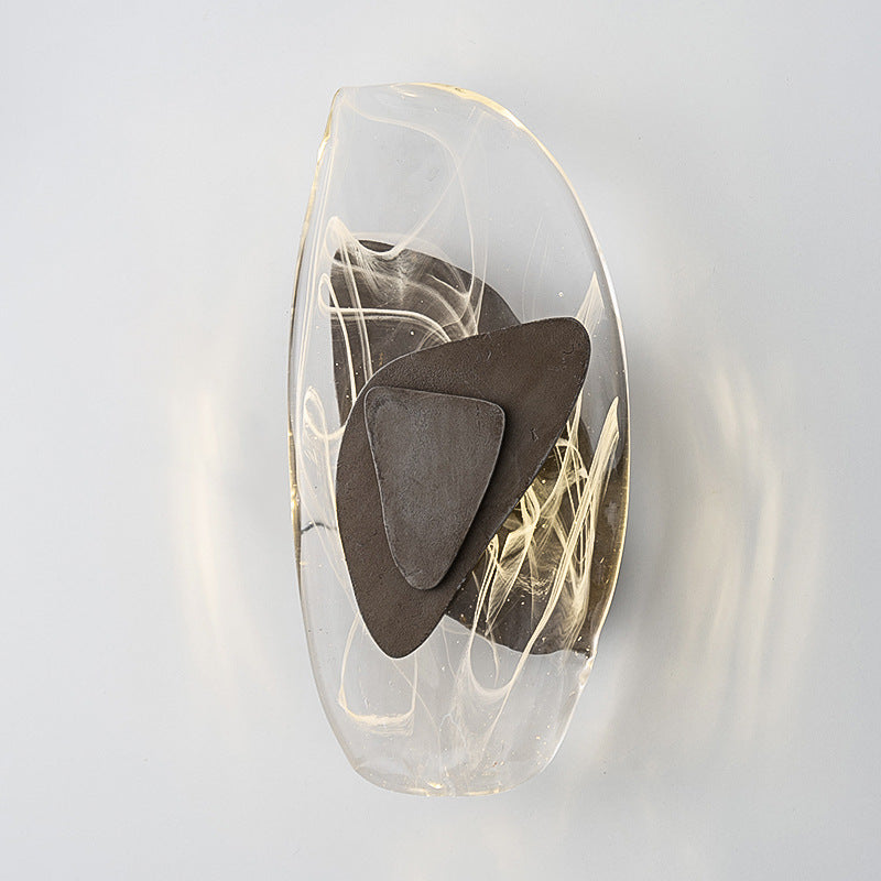 Decorative wall sconce with a brown abstract design on a white background
