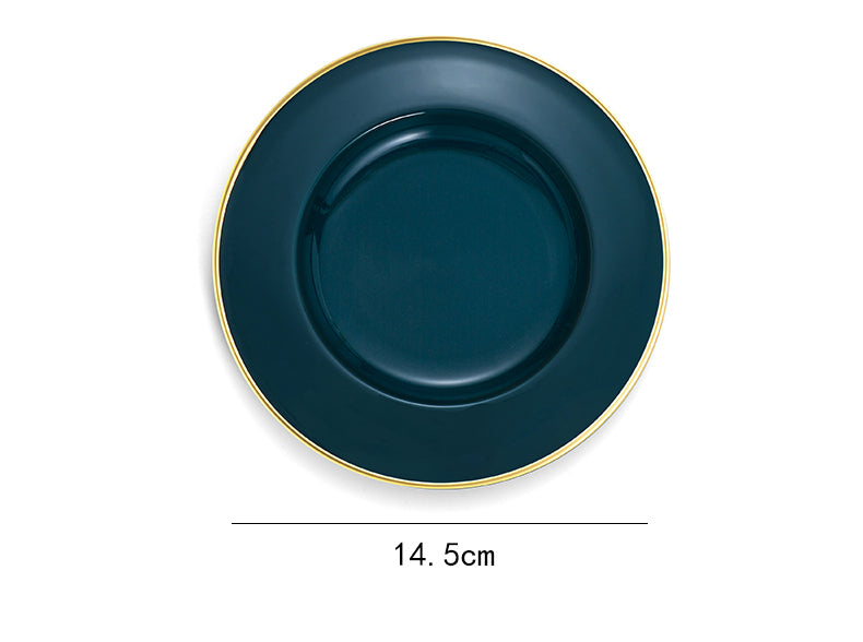 Dark blue plate with gold rim on a white background