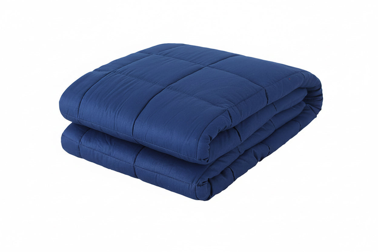 Folded blue comforter on a white background