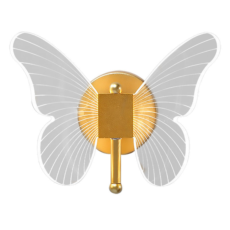 Gold butterfly-shaped wall sconce on a white background