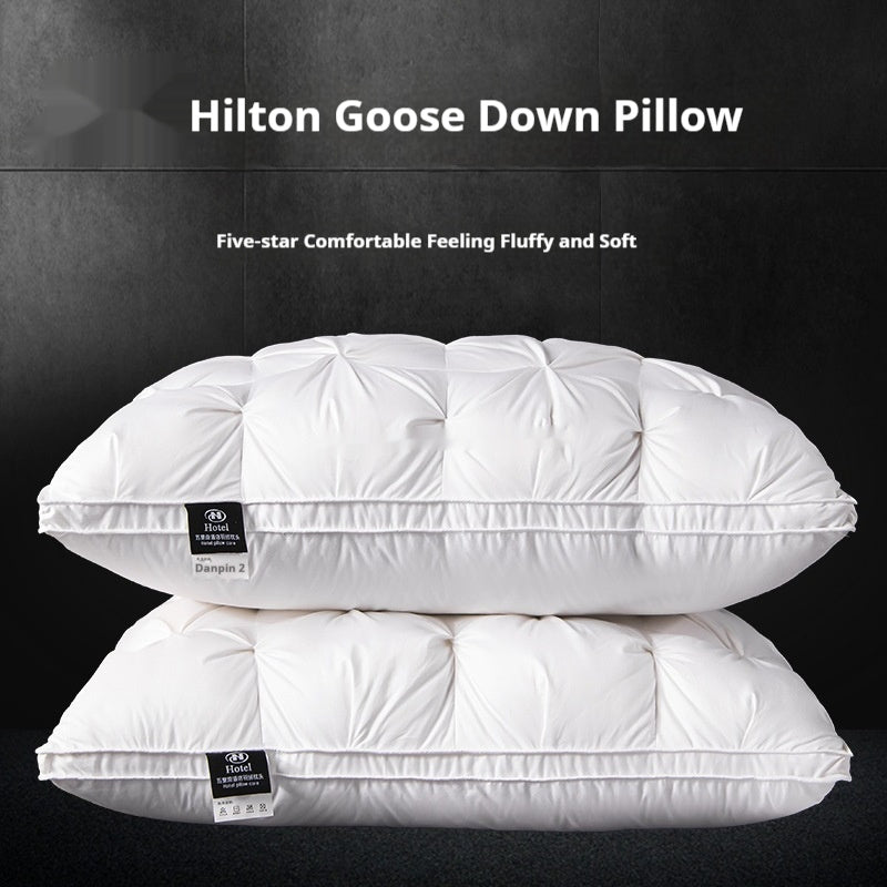 Two white goose down pillows stacked on a black background with Hilton branding.