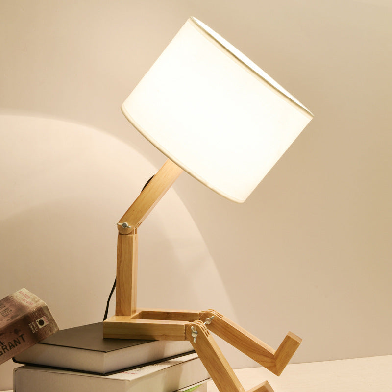 Wooden adjustable desk lamp with a white light on a neutral background