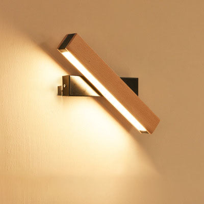 Modern wall-mounted light fixture on a beige wall