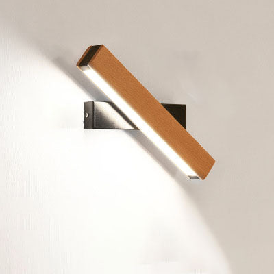 Modern wall light fixture with wooden finish on a white wall
