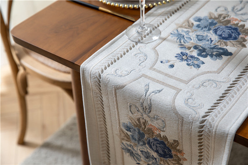 Embroidered floral table runner on a wooden table