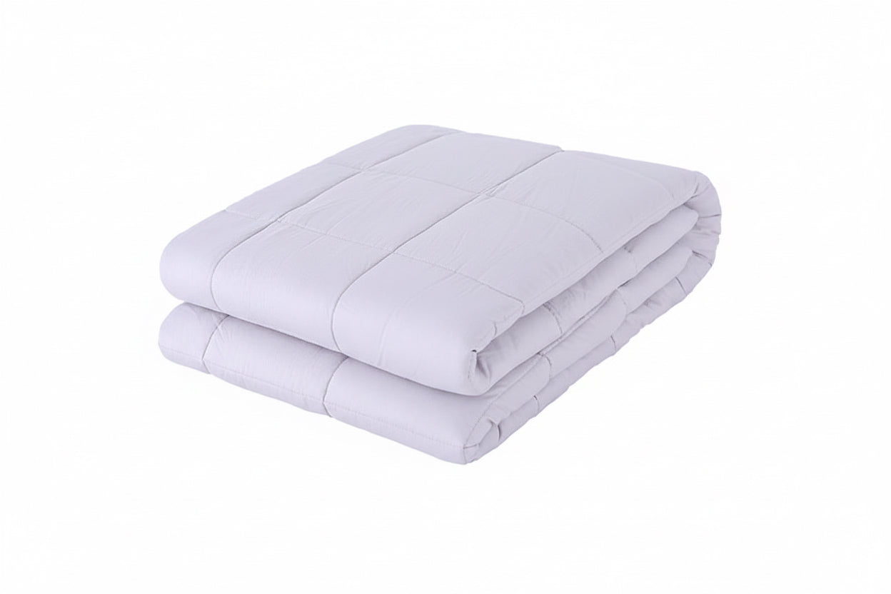 Folded light gray comforter on a white background