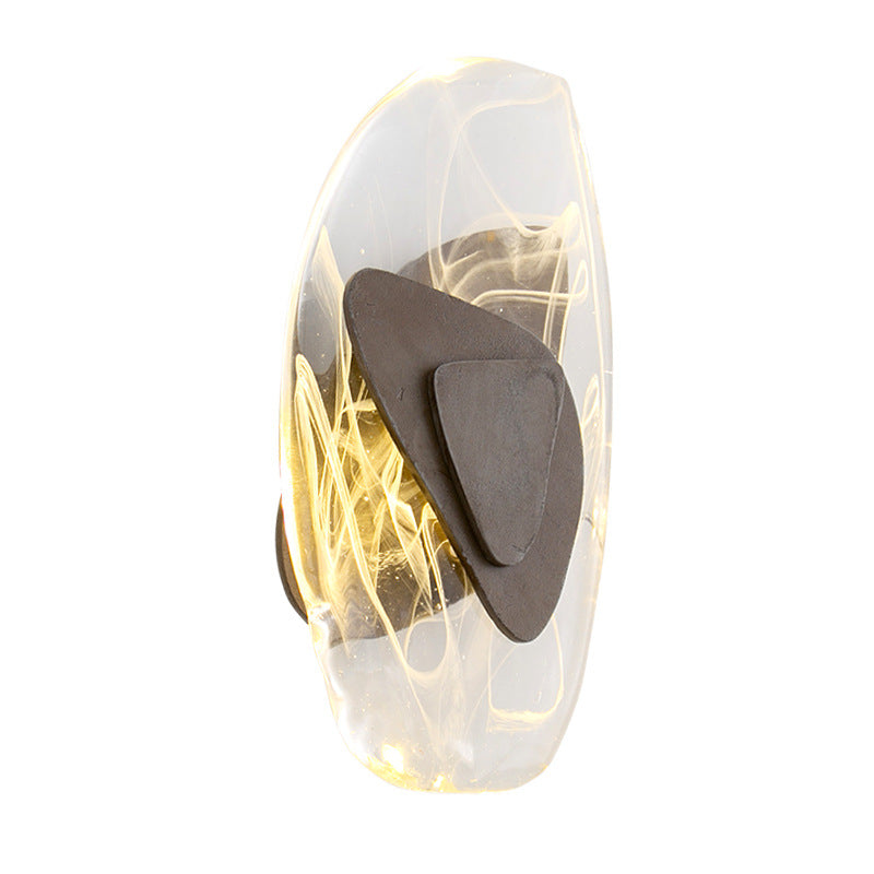 Wall-mounted light fixture with a glass shade on a white background