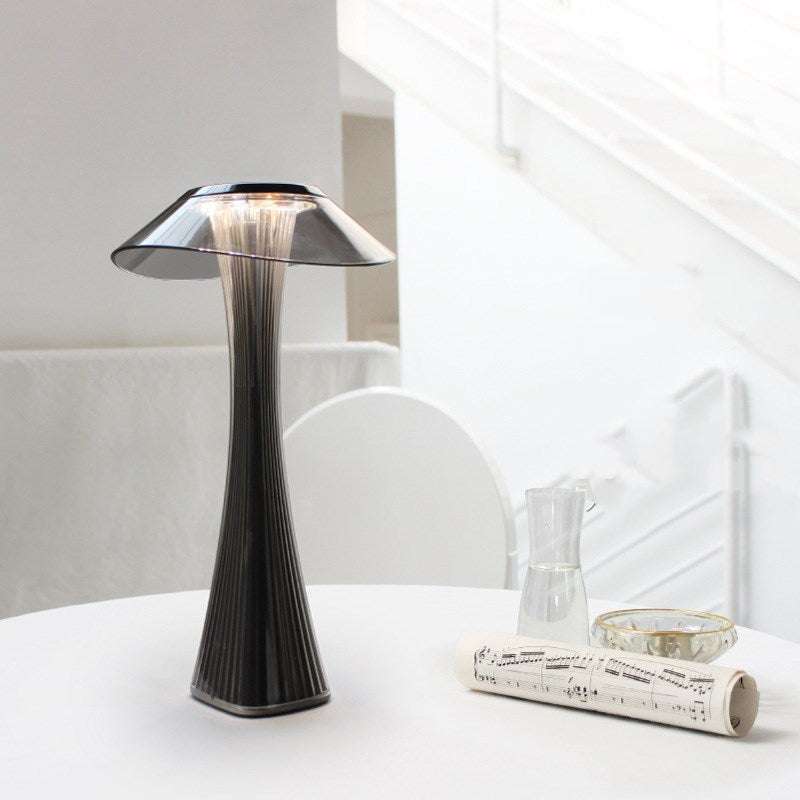 Modern table lamp on a white surface with a minimal background