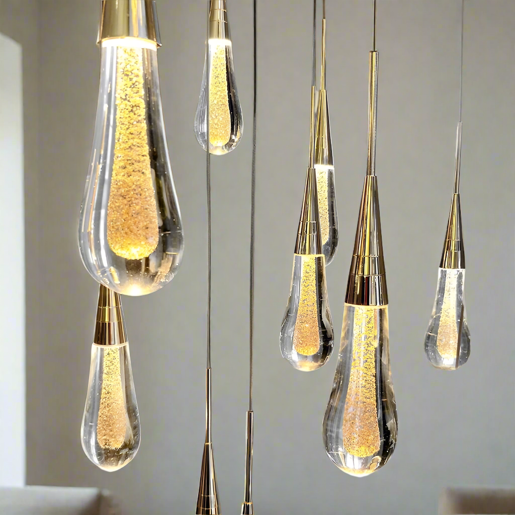 Modern pendant lights with glass and gold accents on a neutral background