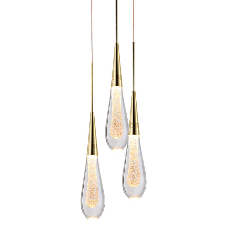 Three modern pendant lights with gold accents on a white background