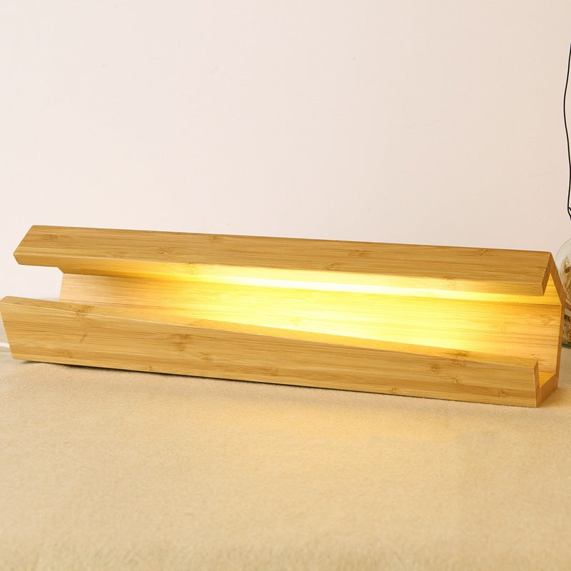 Wooden shelf with warm light on a beige surface
