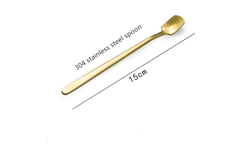 Gold spoon with measurements on a white background