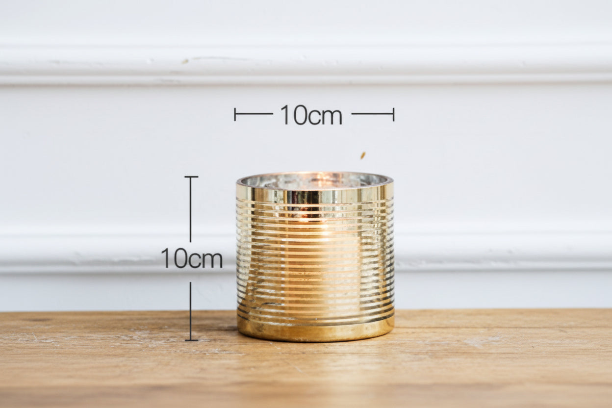 Gold ribbed candle holder on a wooden surface with measurements indicated.