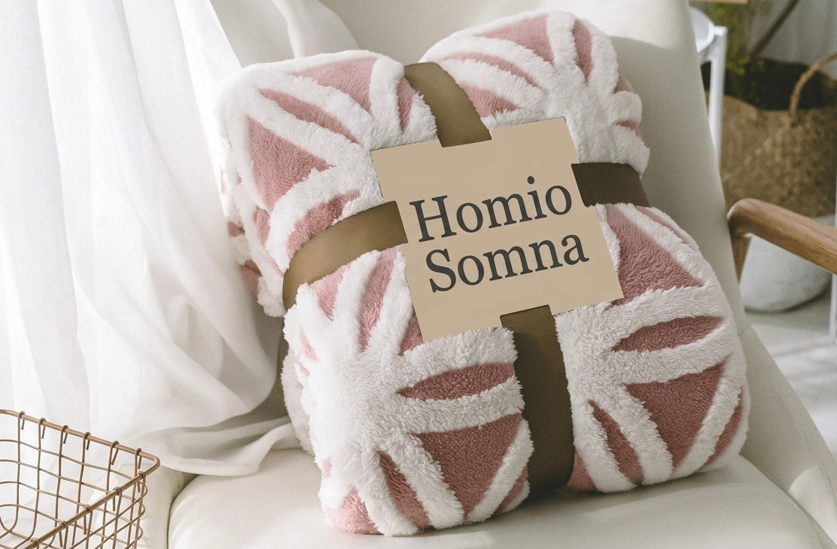 Fluffy pink blanket with 'Homio Somna' label on a chair