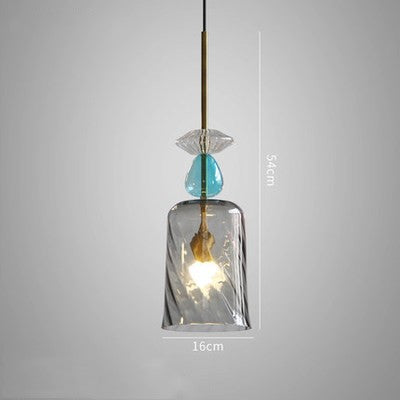 Modern pendant light with glass shade and blue accent on a gray background