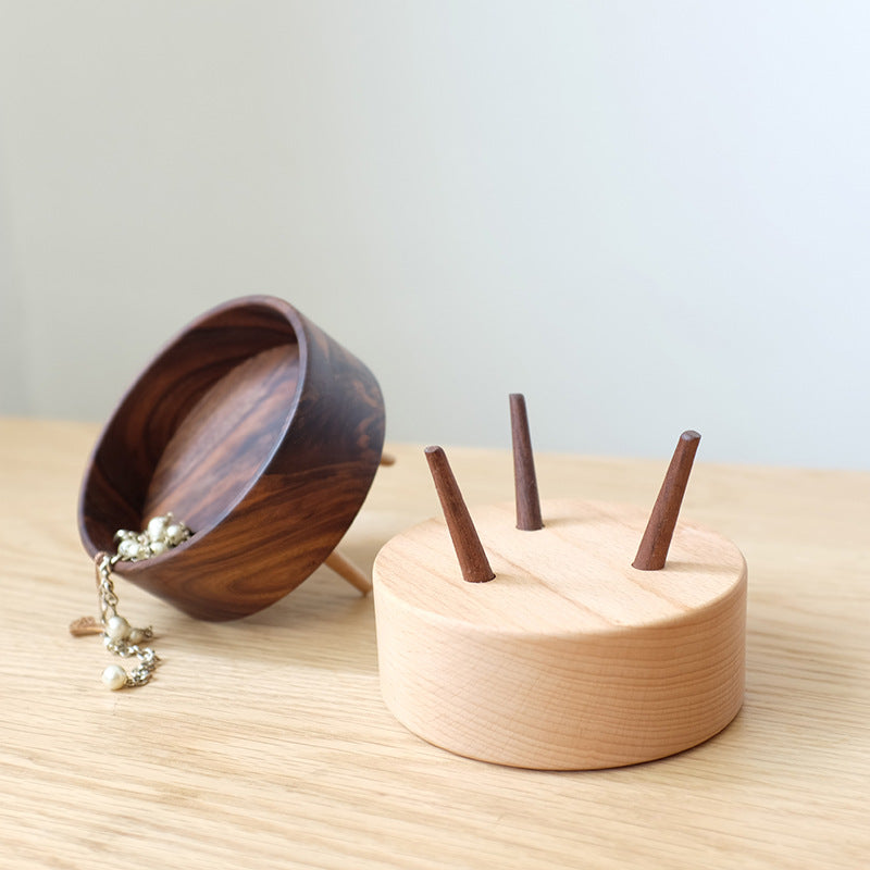 Wooden bowl with a small wooden stand on a light surface