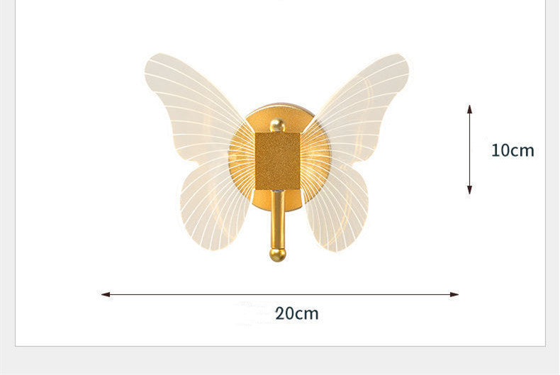Butterfly-shaped wall light fixture with gold center and white wings, shown with dimensions on a white background.