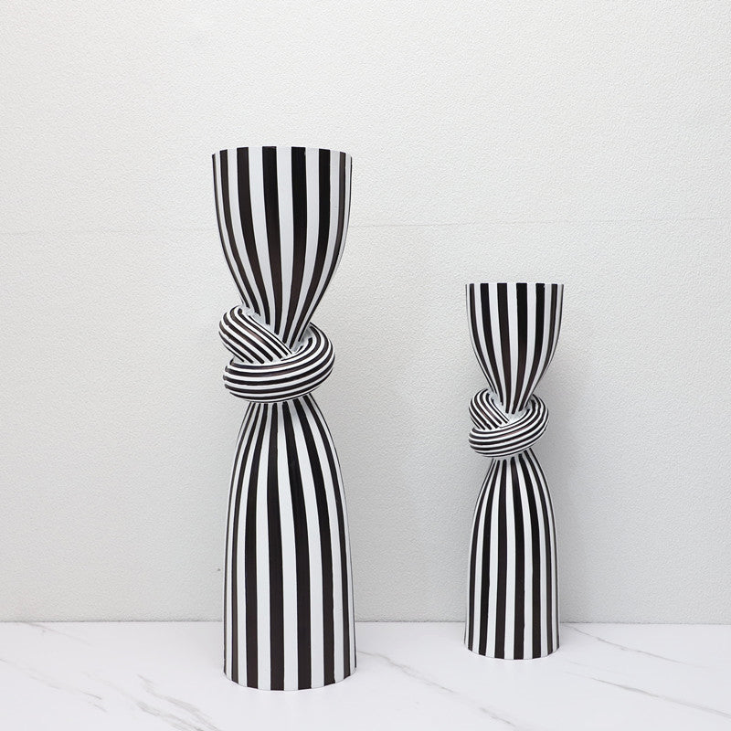 Two black and white striped vases on a white background
