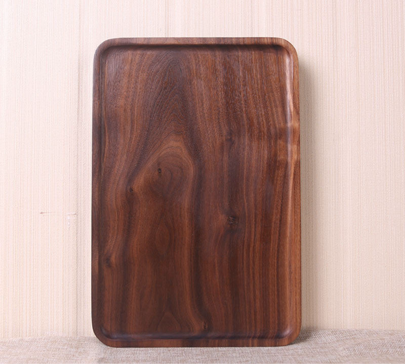 Wooden tray with a rich brown finish on a light background