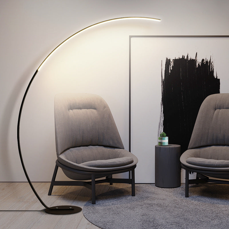 Modern interior with gray chairs, a floor lamp, and abstract art on the wall.