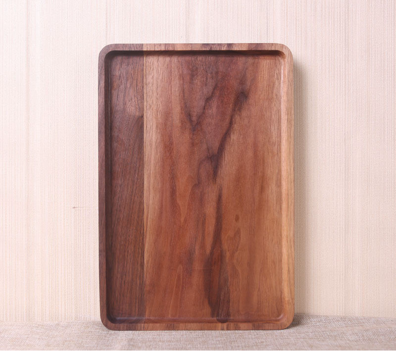 Wooden tray on a light wooden floor with a neutral background