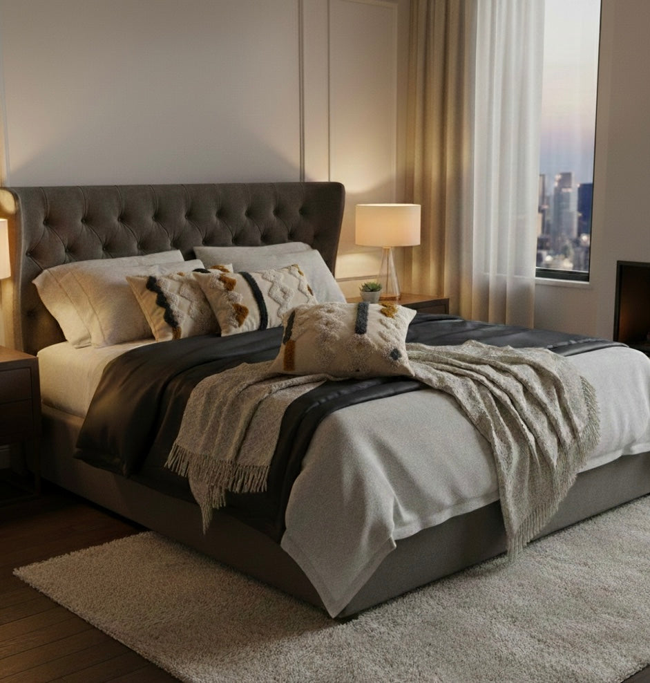 Modern bedroom with a large bed featuring textured bedding and pillows.