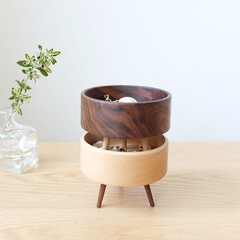 Wooden planter with a smaller wooden bowl inside on a light wood surface.