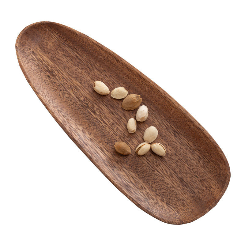 Wooden tray with nuts on a white background