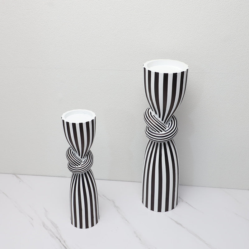 Two black and white striped vases on a light gray background