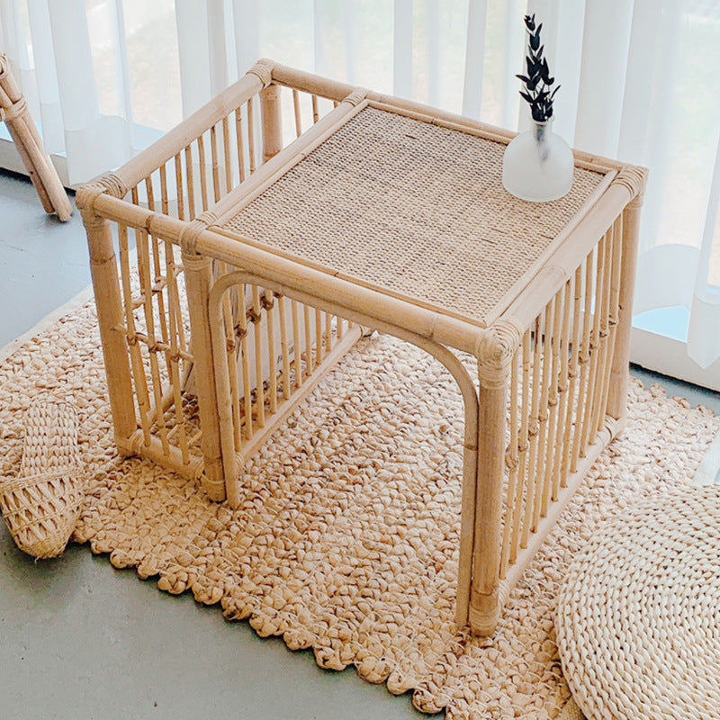 Rattan side table with woven surface on a textured rug