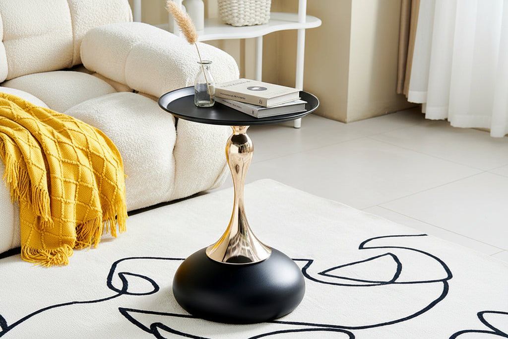 Modern side table with gold and black design in a living room setting
