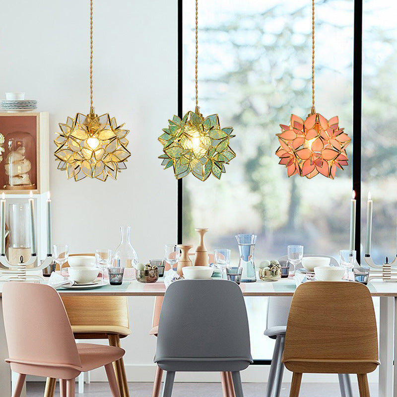 Dining room with colorful pendant lights and a table set for a meal.
